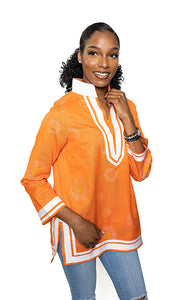 Orange; tunic with white trim & collar.  Gold circles